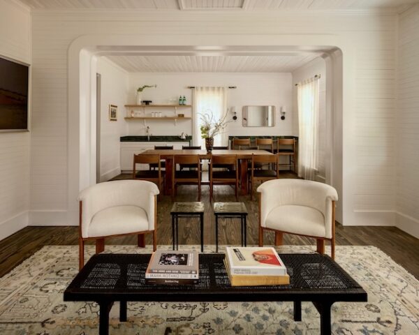 Stylish living room and dining area with vintage decor and modern furniture