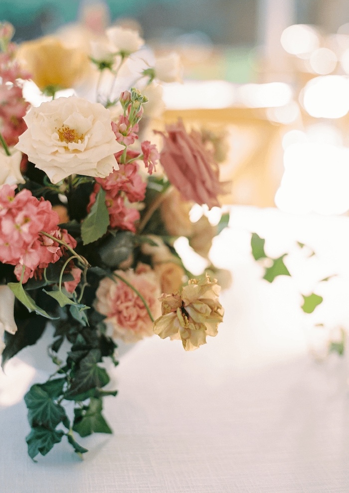 Elegant flower arrangement with white and pink roses on a soft-lit table