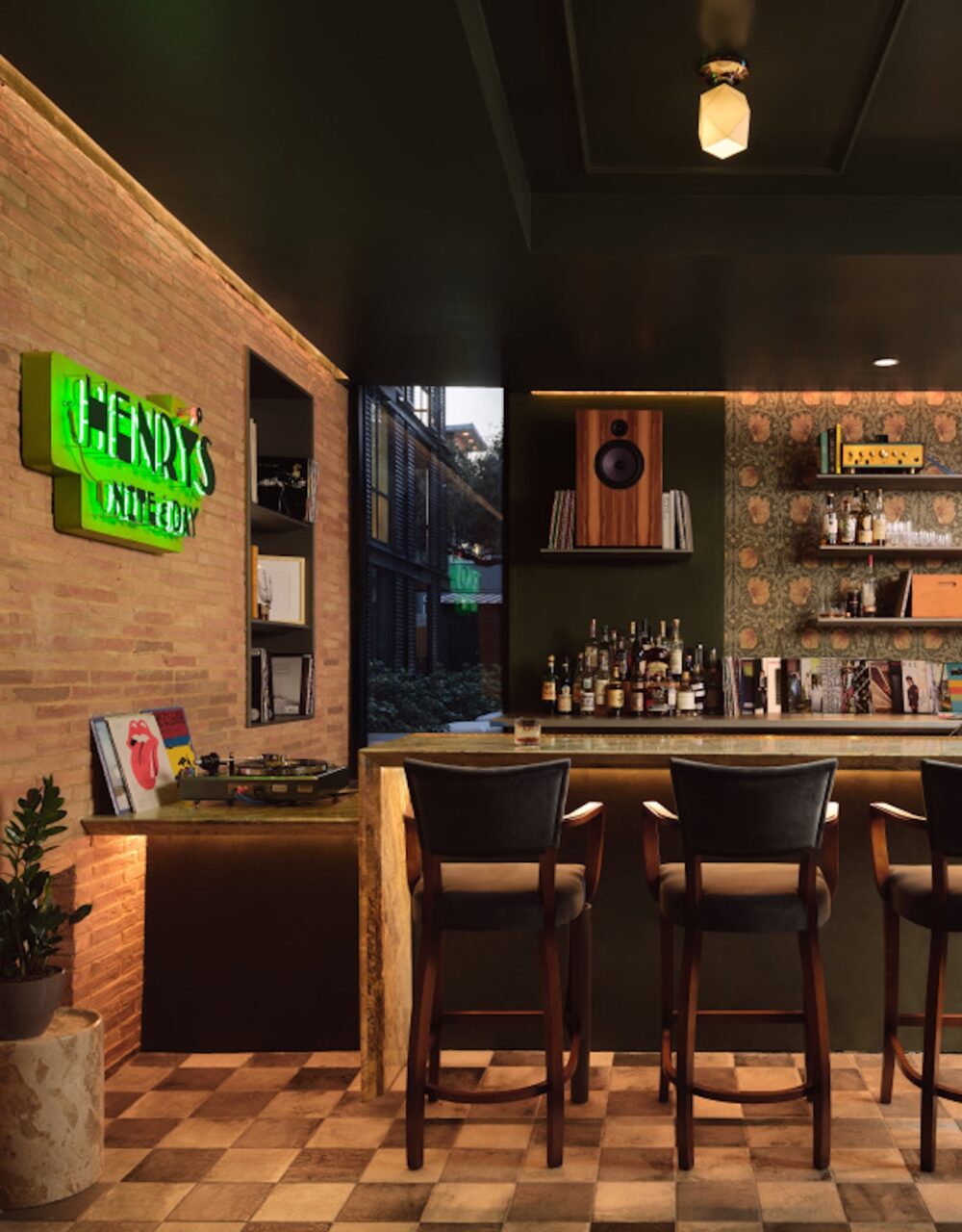 Stylish vintage bar interior with stools and a neon sign on exposed brick wall
