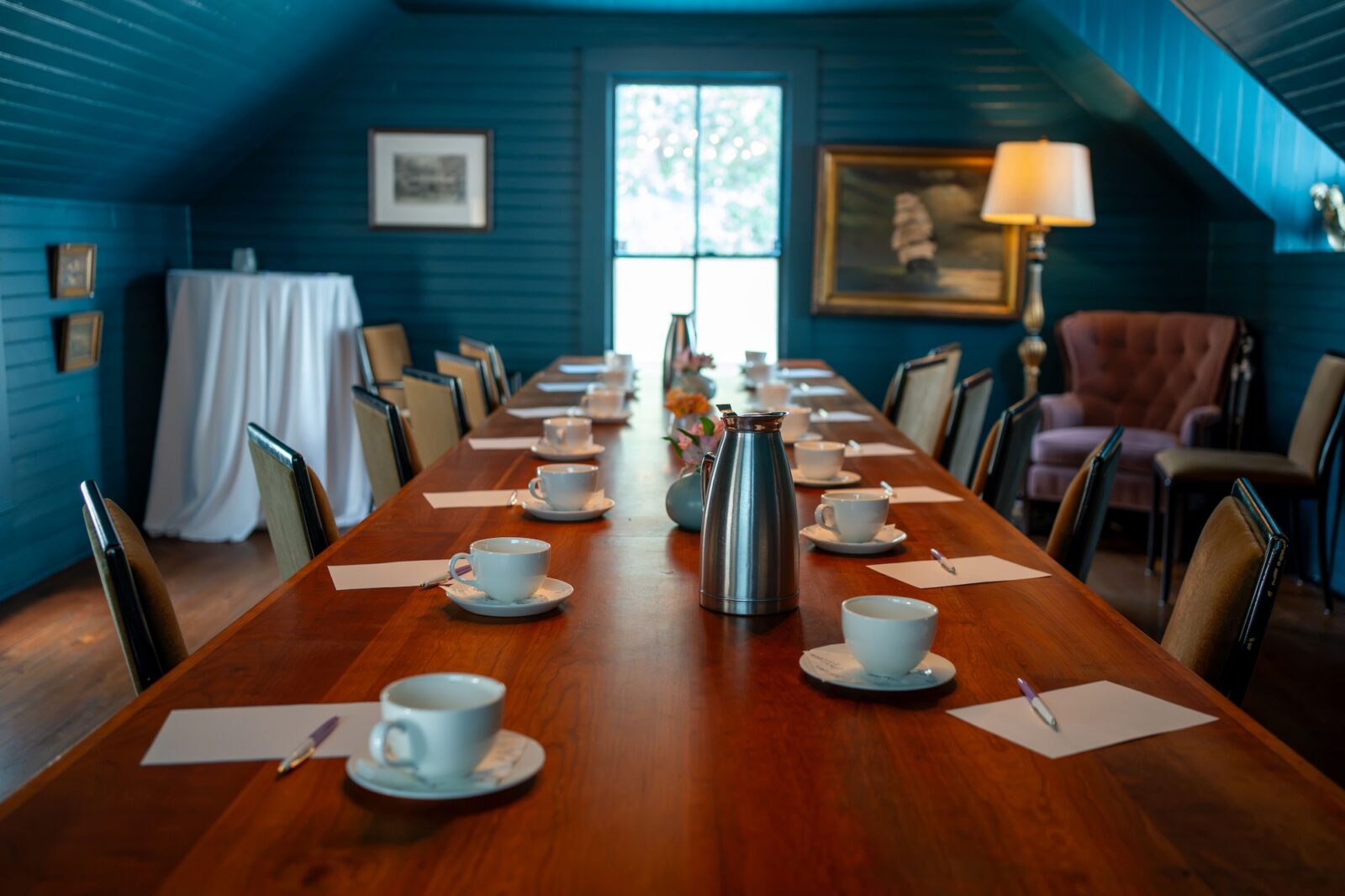 Elegant conference room setup with coffee cups on a wooden table