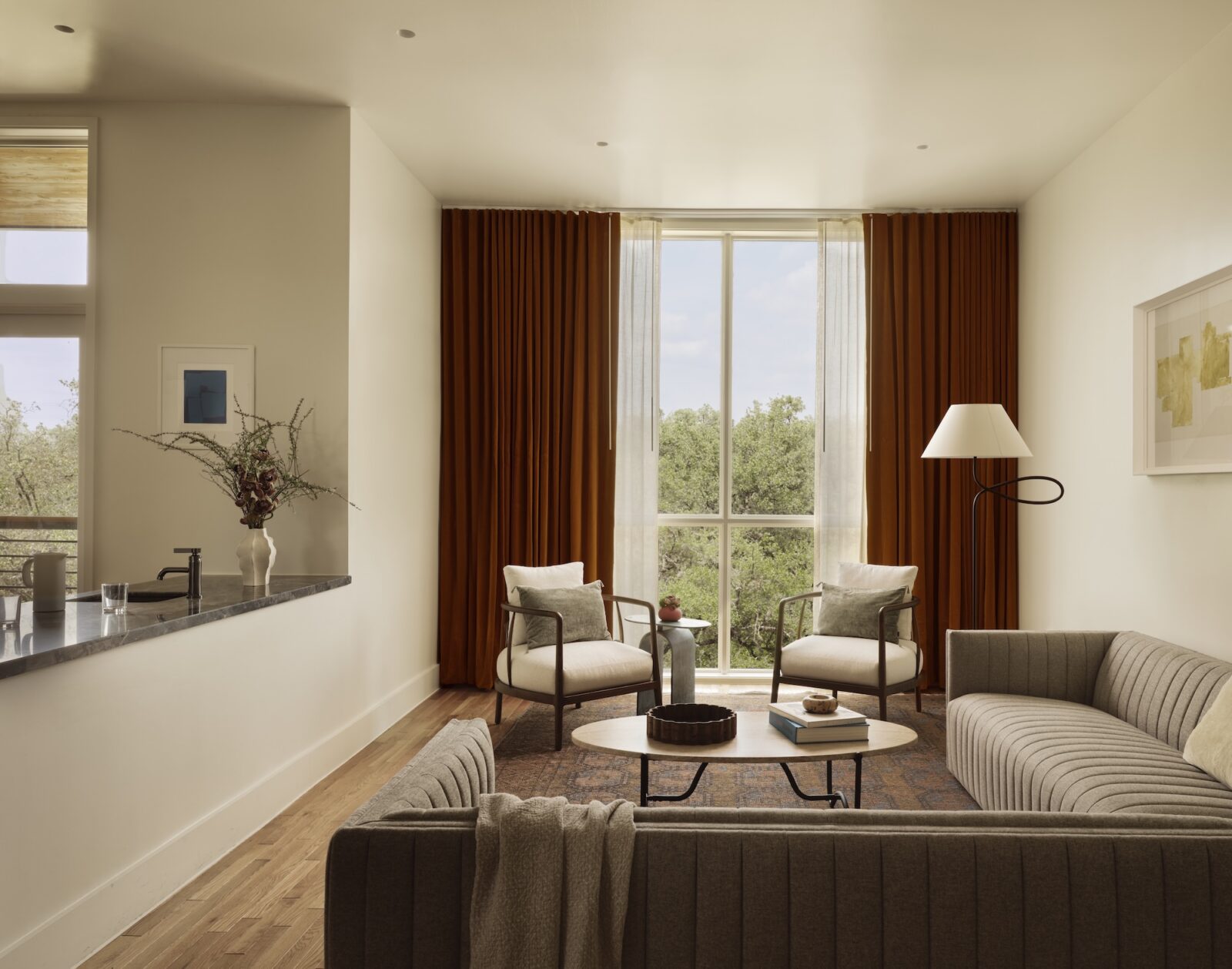 Modern living room with large window and cozy seating area